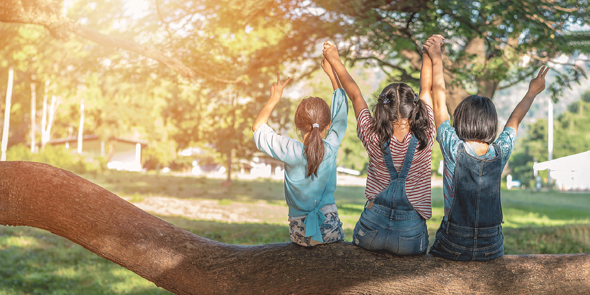 Children friendship concept with happy girl kids in the park having fun sitting under tree shade playing together enjoying good memory and moment of student lifestyle with friends in school time day