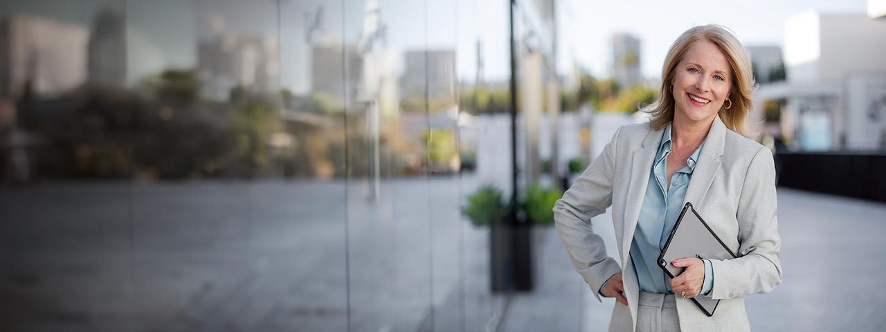 Mature business executive professional woman portrait, in suit outside of office in business district