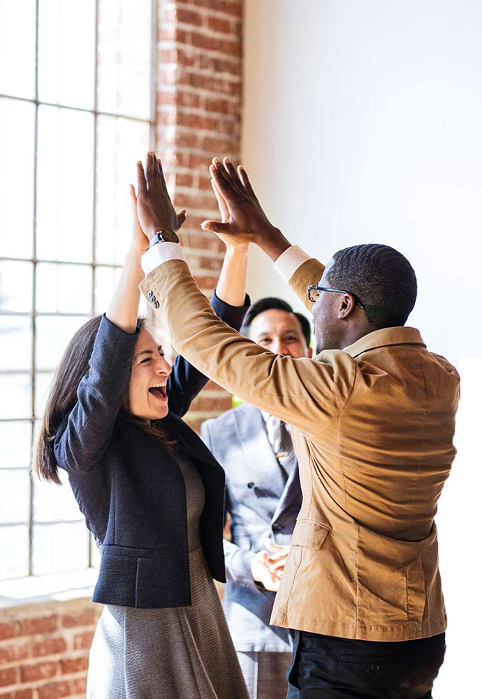 Successful business people doing a high five