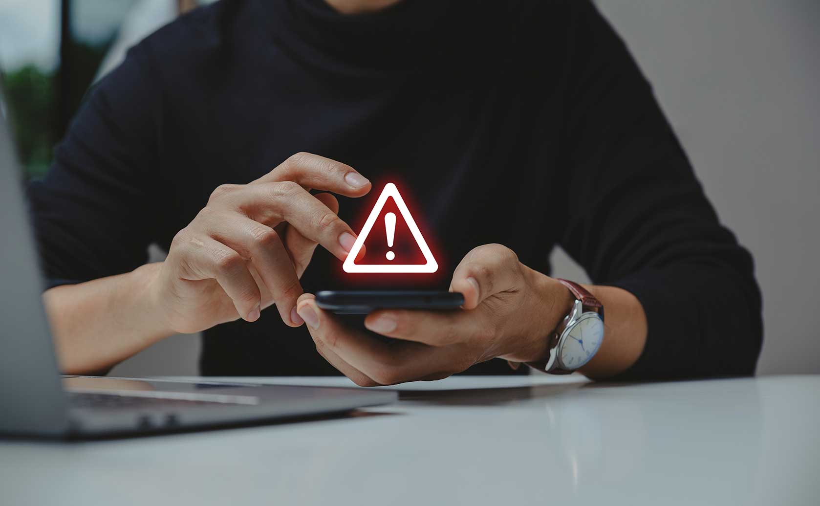 Person on phone with warning sign