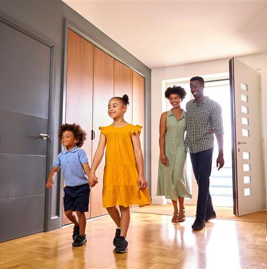 Family walking through home door