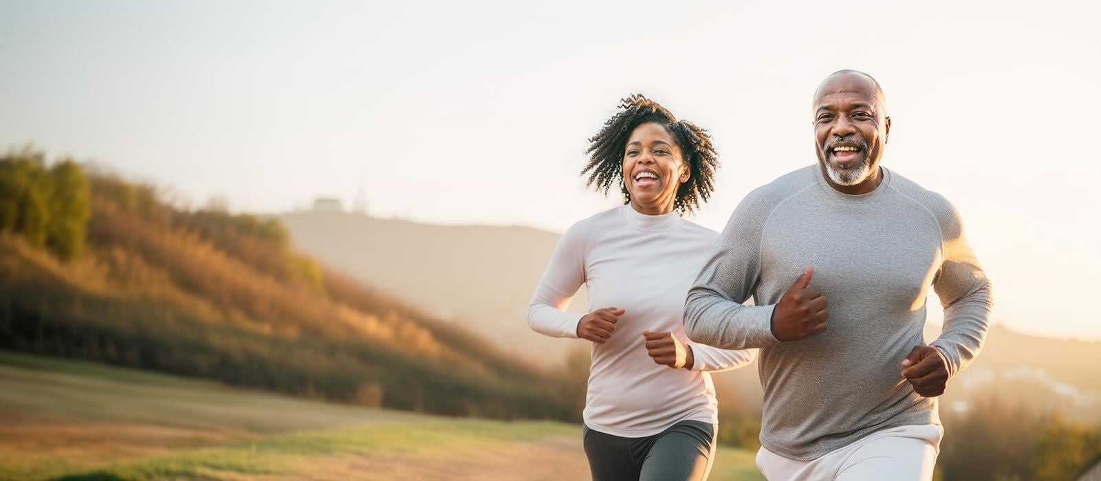 An african american couple of middle aged adults running in the morning, healthy lifestyle jogging, happy run