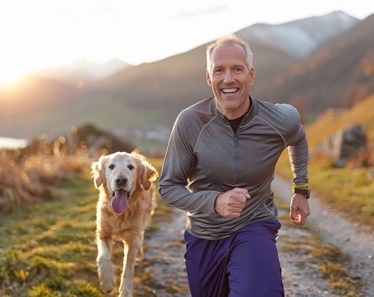 Older man jogging with his dog