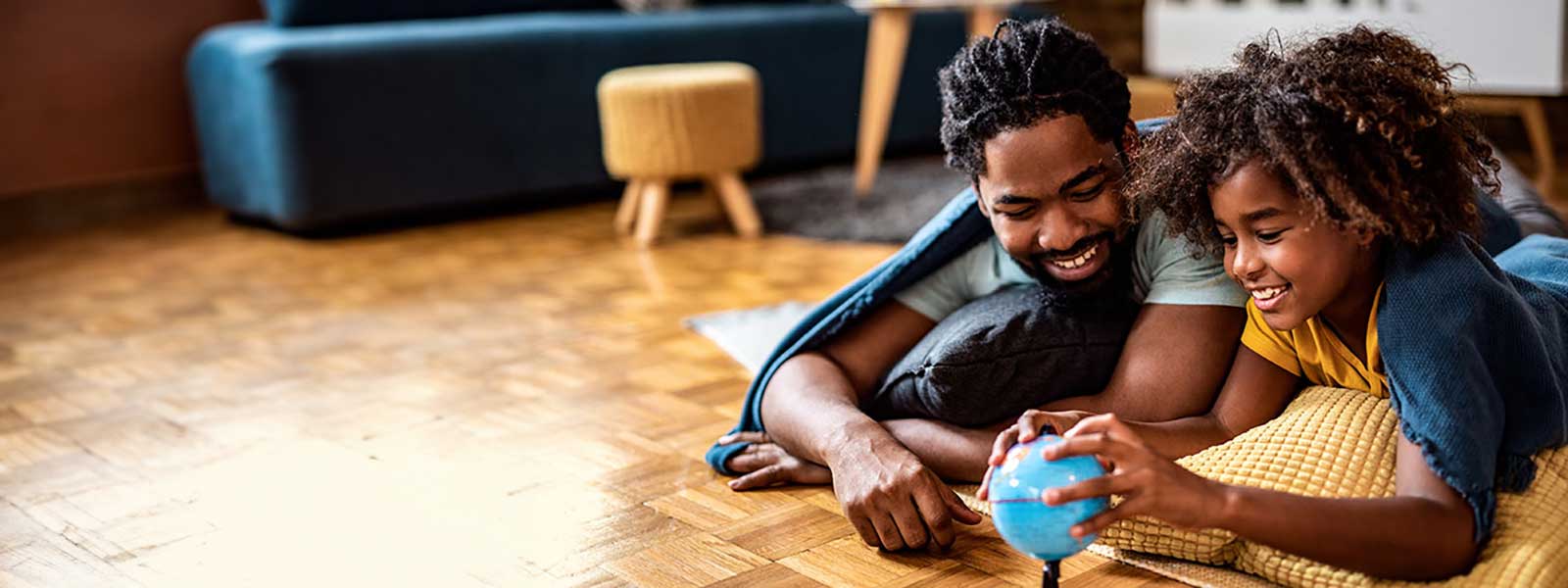 Father and daughter looking at globe