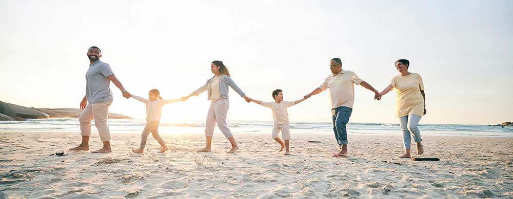Family, walking and beach with holding hands for love in outdoor on vacation with sunshine. Care, generations and children or parents at ocean for travel in summer with bond, freedom in mockup space. Family, walking and beach with holding hands for love in outdoor on vacation with sunshine. Care, generations and children or parents at ocean for travel in summer with bond, freedom in mockup space.