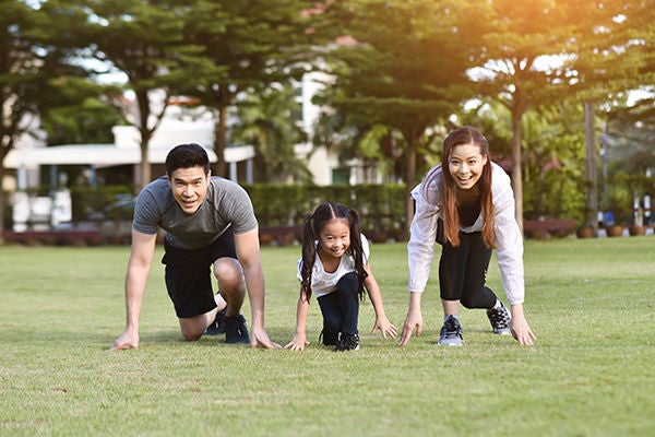 Asian family exercising at park outdoor. 