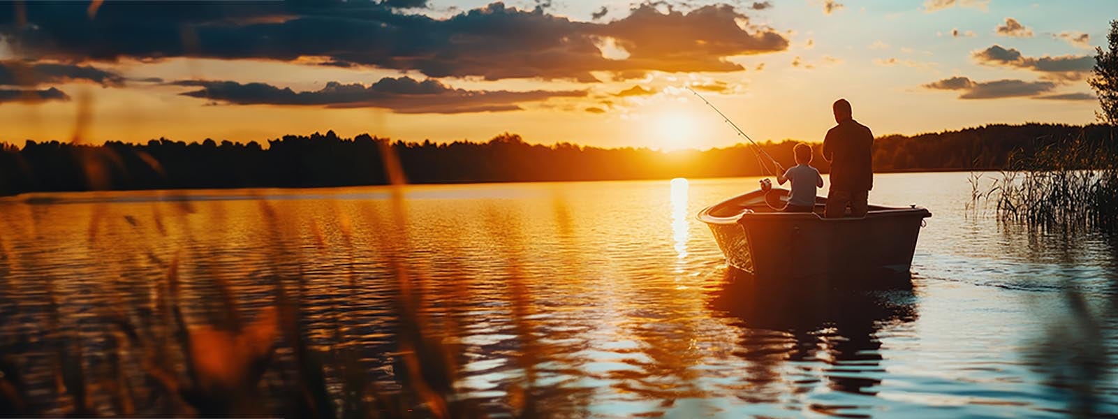 Father and Son Fishing Together on a Tranquil Lake at Sunset - A Cherished Family Recreation Experience