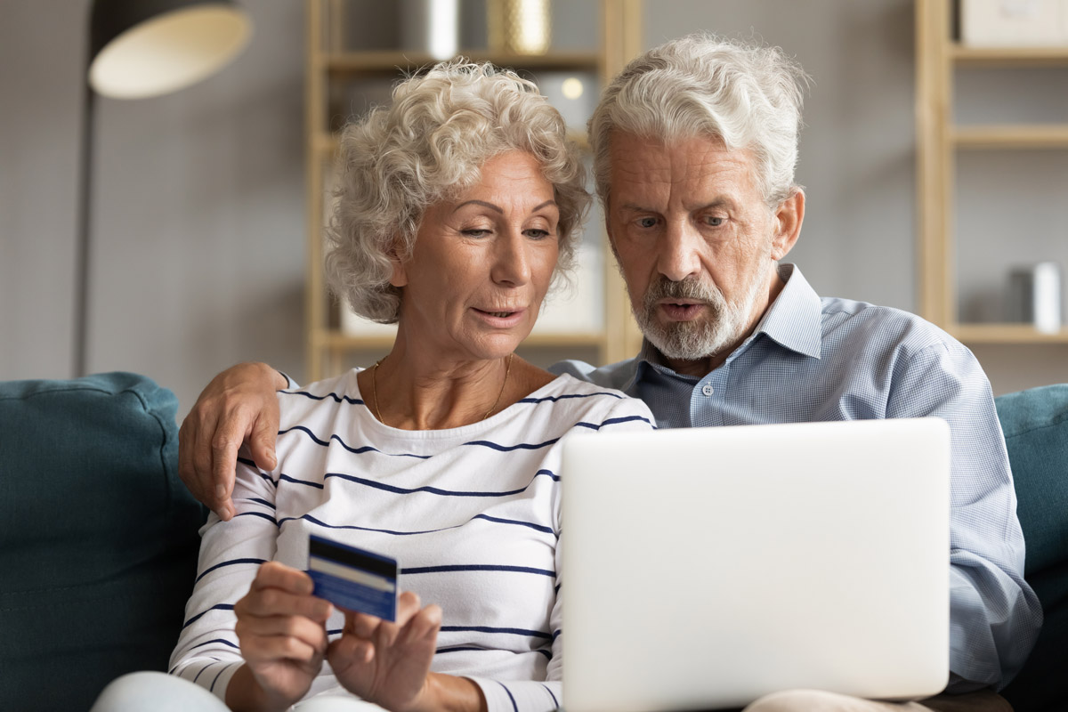 Senior couple use online websites bank credit card buying online