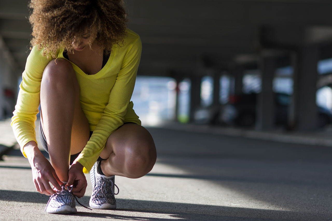 Portrait of mixed race girl tying a shoelace before workout