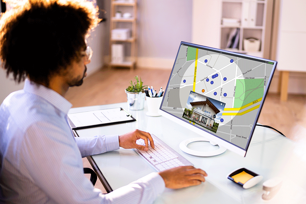 person-on-computer-looking-at-map-and-home