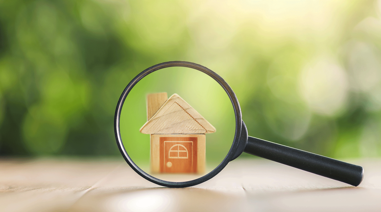 Wooden houses and magnifying glass. Property valuation. Home appraisal. Choice of location for the construction. House searching concept. Search for housing and apartments. 