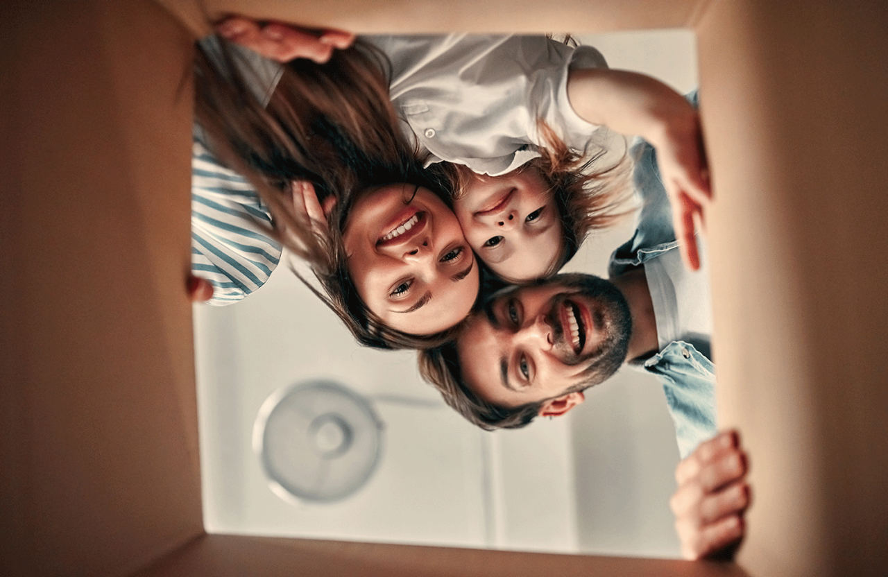 family looking into moving box