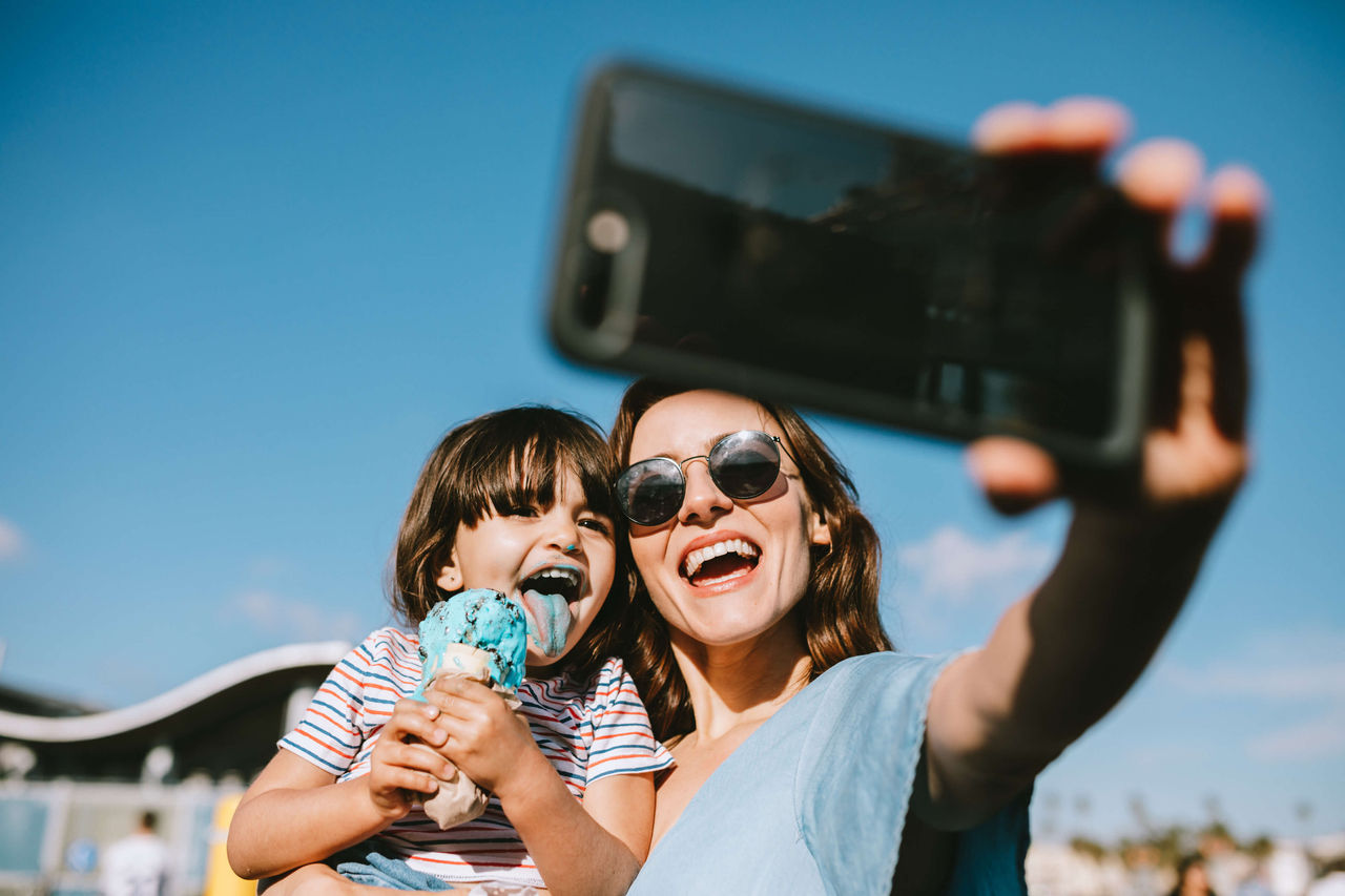 mom and child at park taking a selfie